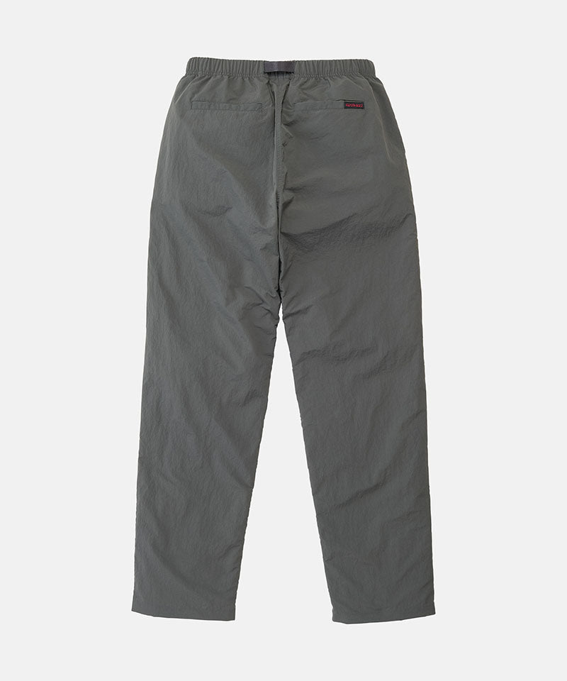 Back view of carbon colored Nylon Gramicci Pants on a light-tone background.
