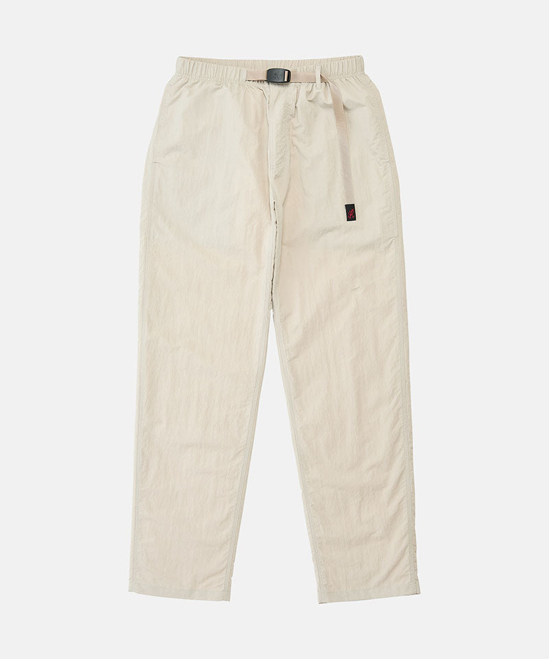 Stone colored Nylon Gramicci Pants with a belt against a light-tone background.