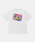 Back view of a Gramicci white Bass Tee with a graphic against a light-tone background.
