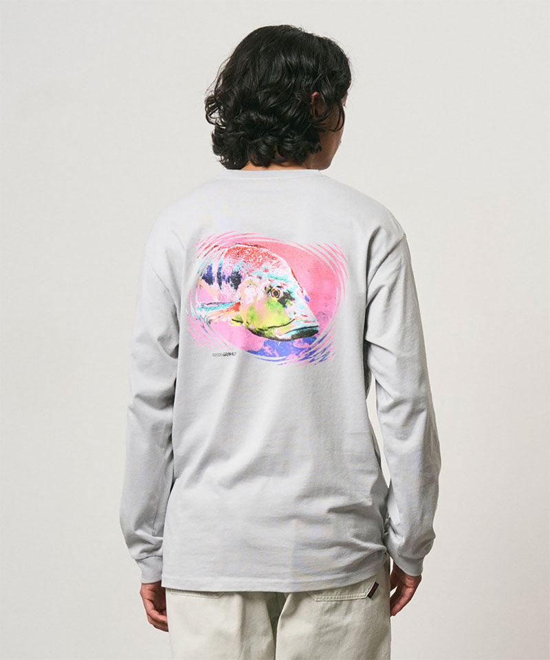 Back view of a model wearing a Gramicci mist colored Bass Long-Sleeve Tee with a graphic against a light-tone background.
