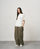 Back view of a Gramicci ash heather Earth Tee with a graphic against a light-tone background.