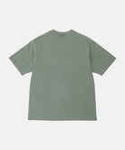 Back view of a Gramicci sage pigment colored Bone Tee Pigment Dyed against a light-tone background.