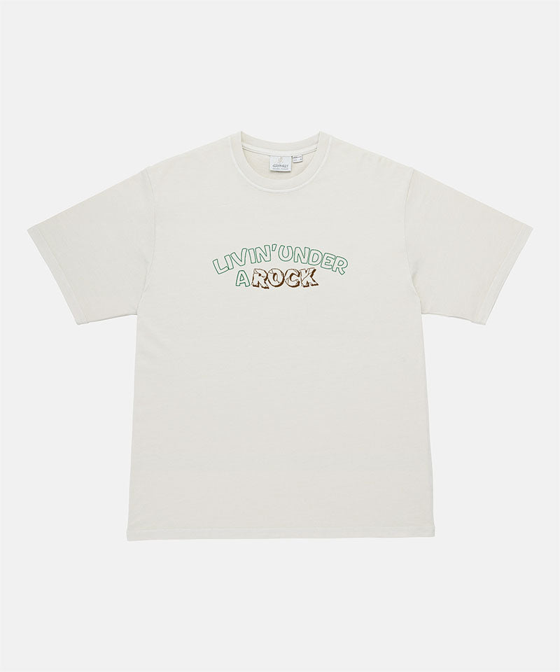 Gramicci natural pigment colored Livin' Tee Pigment Dyed with a Livin' Under A Rock graphic against a light-tone background.