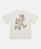 Back view of a Gramicci natural pigment colored Livin' Tee Pigment Dyed with a running man graphic against a light-tone background.