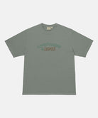 Gramicci sage pigment colored Livin' Tee Pigment Dyed with a Livin' Under A Rock graphic against a light-tone background.