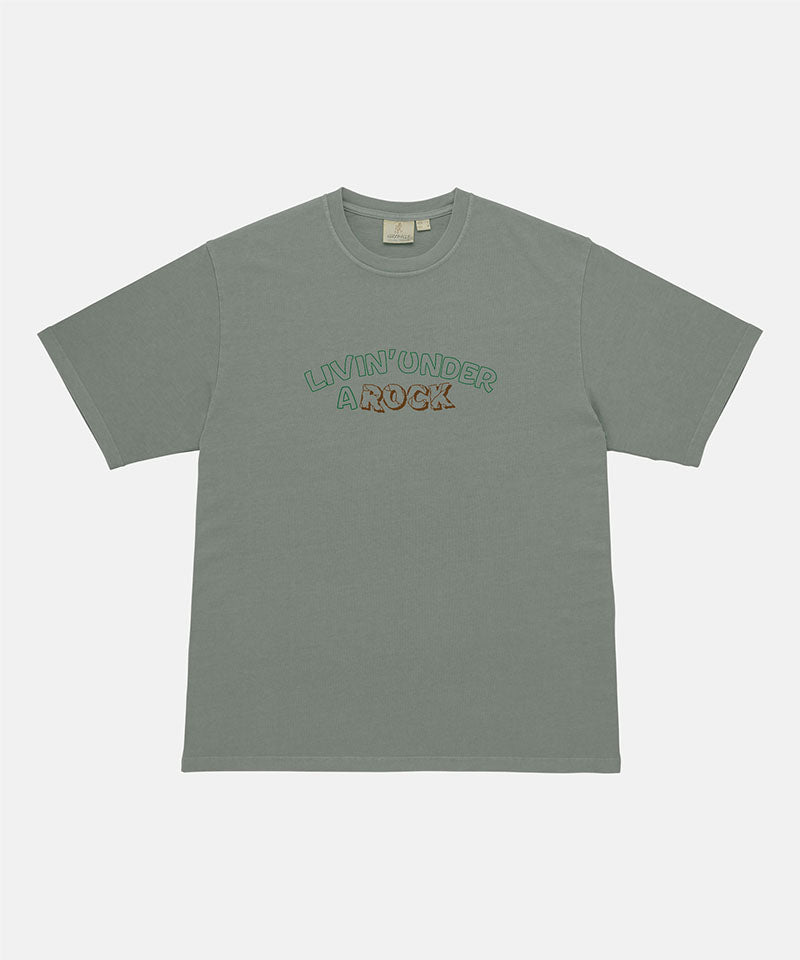 Gramicci sage pigment colored Livin' Tee Pigment Dyed with a Livin' Under A Rock graphic against a light-tone background.