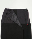 Close-up view of a black Gramicci Thermal Fleece Skirt against a light-tone background.