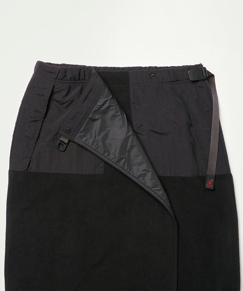 Close-up view of a black Gramicci Thermal Fleece Skirt against a light-tone background.
