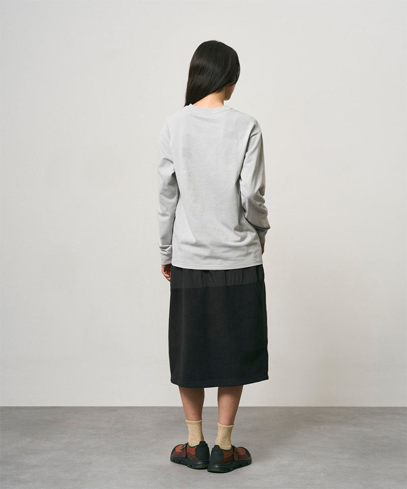 Model wearing a black Gramicci Thermal Fleece Skirt and a grey sweatshirt on a light-tone background.