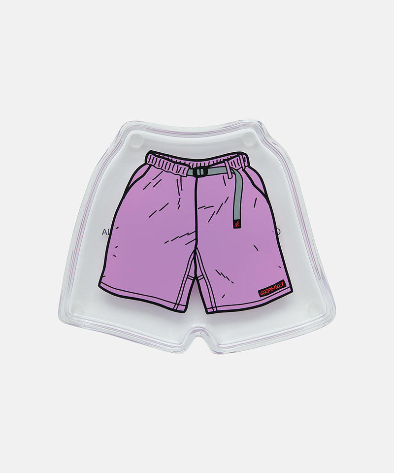 Small tray with purple Gramicci shorts with a belt against a light-tone background