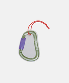 Olive Gramicci & retaW Carabiner Car Tag air freshener against a light-tone background.