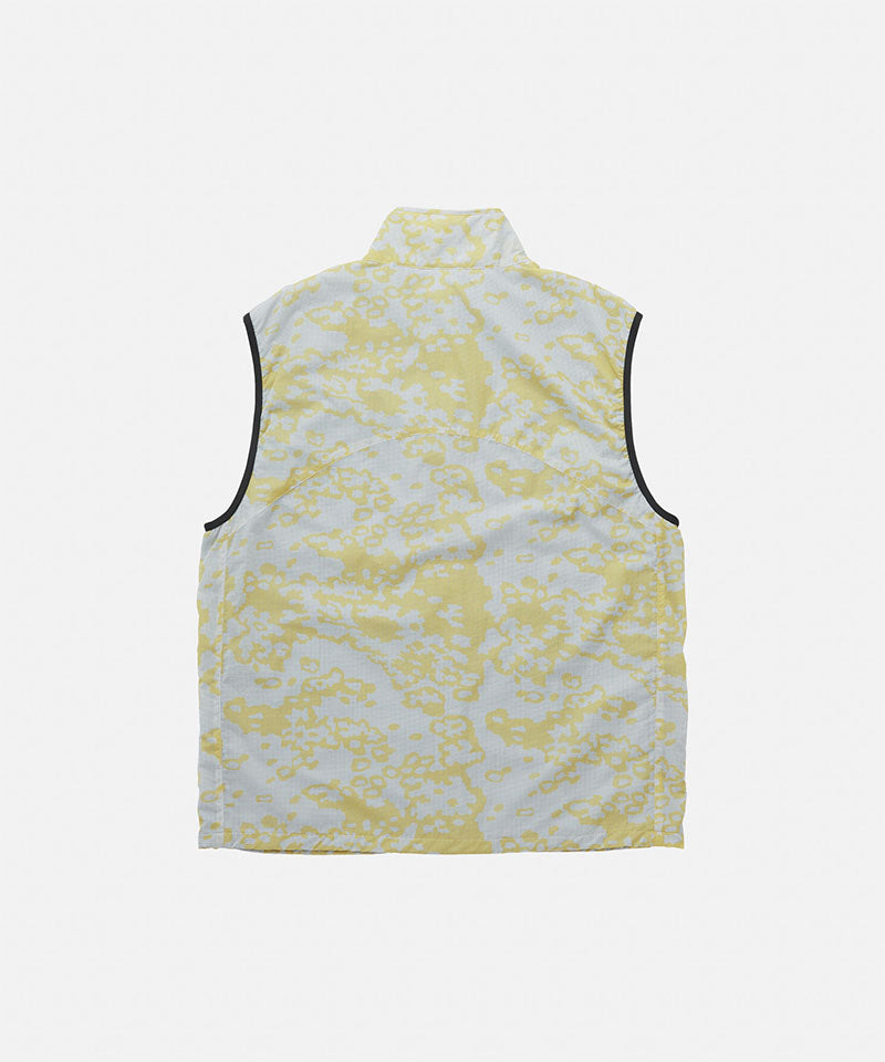 Back view of a Gramicci yellow and grey grid camo Flyweight Vest against a light-tone background.