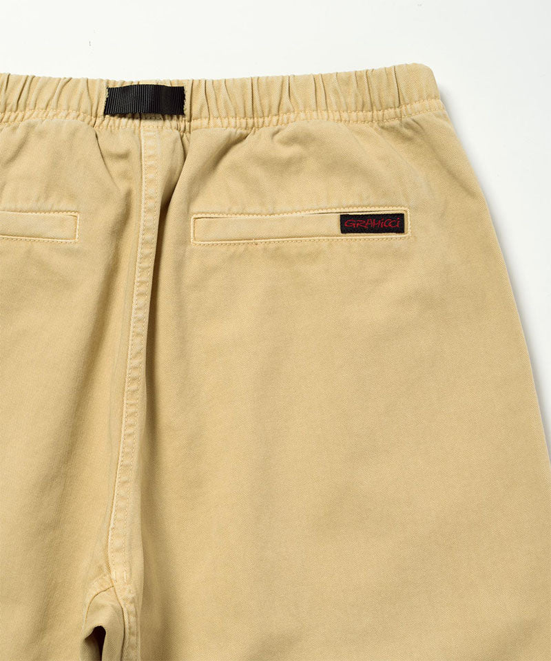 Back view close-up of Natural Dyed Gramicci Pant Straight Fit in the color chino against a light-tone background.
