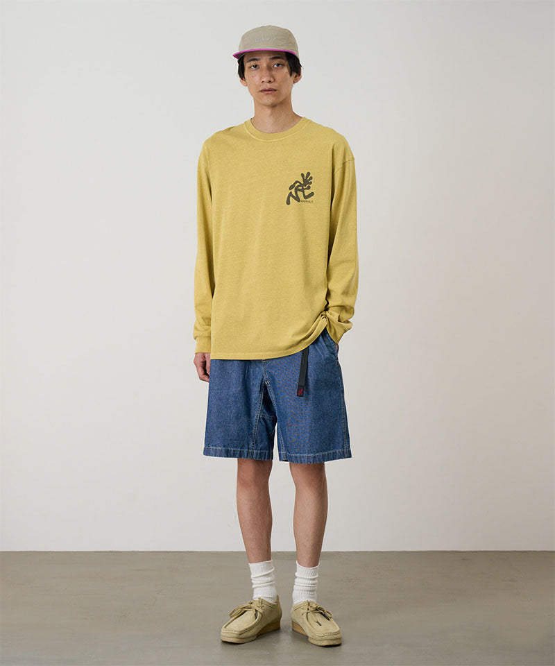 Model wearing blue Gramicci Japanese Chambray Shorts and a yellow shirt on a light-tone background.