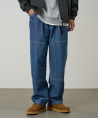 Gramicci Japanese Chambray Double Knee pant in blue worn by a model against a light tone background.
