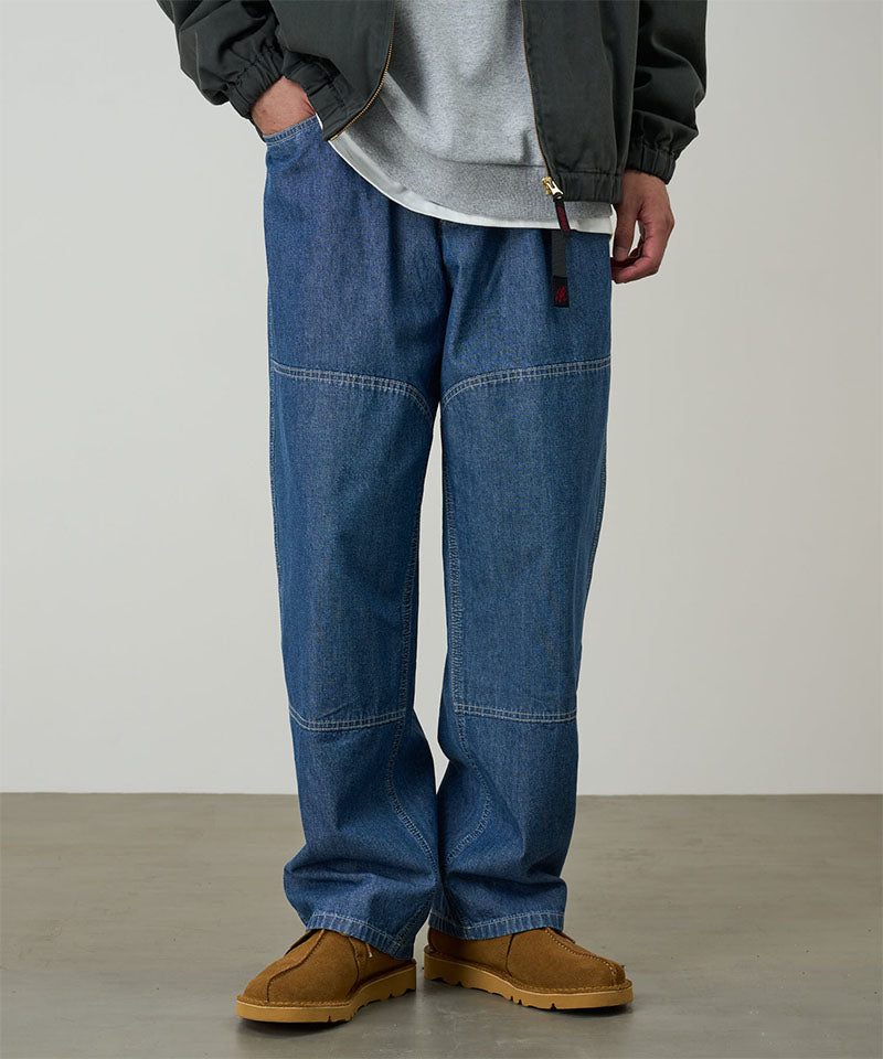 Gramicci Japanese Chambray Double Knee pant in blue worn by a model against a light tone background.
