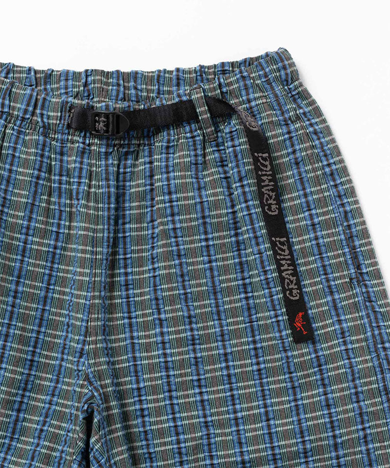 Close-up of a blue multistripe Gramicci Gramicci O.G. G-Short Seersucker Plaid on a light-tone background.