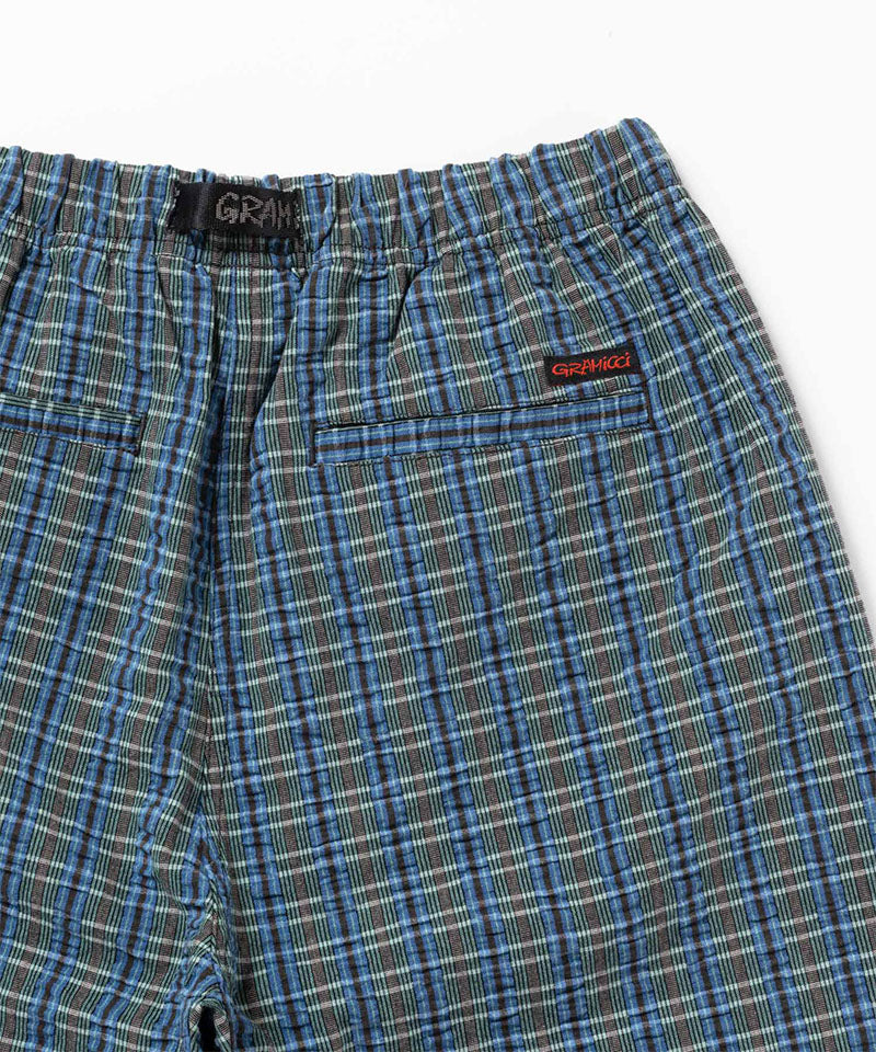 Back view close-up of the blue multistripe Gramicci Gramicci O.G. G-Short Seersucker Plaid on a light-tone background.