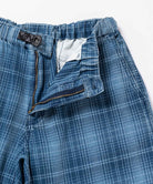 Close-up of a indego Gramicci Lagoon Short Denim Plaid on a light-tone background.