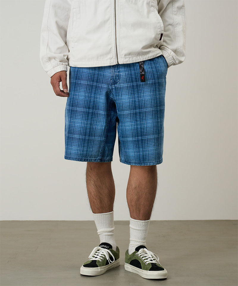 Model wearing a Gramicci indego Lagoon Short Denim Plaid against a light-tone background.