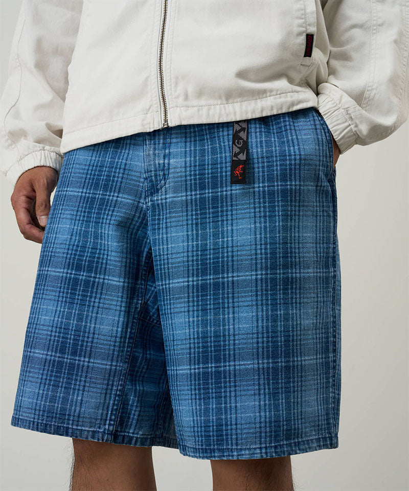 Model wearing a Gramicci indego Lagoon Short Denim Plaid against a light-tone background.