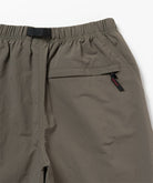 Back view close-up of jade green Gramicci Nylon Block Shorts on a light-tone background.