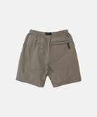 Back view of jade green Gramicci Nylon Block Shorts on a light-tone background.