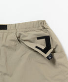 Close-up view of milk tea colored Gramicci Nylon Cliff Short on a light-tone background.