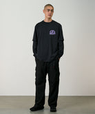 Model wearing black Gramicci Convertible Cargo Pants and a black shirt on a light-tone background.