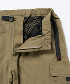 Close-up view of khaki Gramicci Convertible Cargo Pants on a light-tone background.