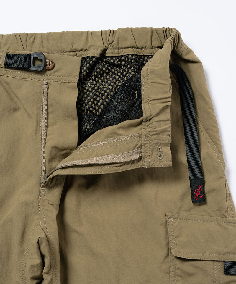 Close-up view of khaki Gramicci Convertible Cargo Pants on a light-tone background.