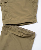 Back view close-up of khaki Gramicci Convertible Cargo Pants highlighting the zip off pant leg on a light-tone background.
