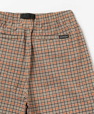 Back view close-up of brick check colored Gramicci Checkered Shell Shorts on a light-tone background.