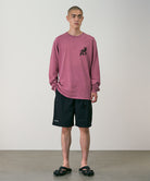 Model wearing black Gramicci Guide Shorts and a red shirt on a light-tone background.