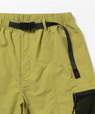 Close-up of Gramicci Guide Shorts in the color field green against a light-tone background.