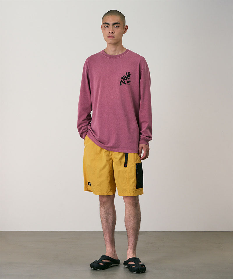 Model wearing mango Gramicci Guide Shorts and a red shirt on a light-tone background.