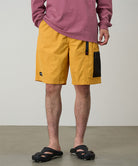 Model wearing mango Gramicci Guide Shorts and a red shirt on a light-tone background.