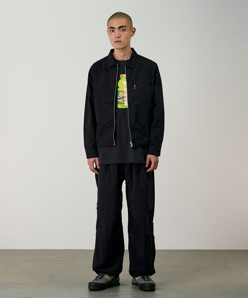 Model wearing black Gramicci Nylon Paneled Trek Pants and a black jacket on a light-tone background.