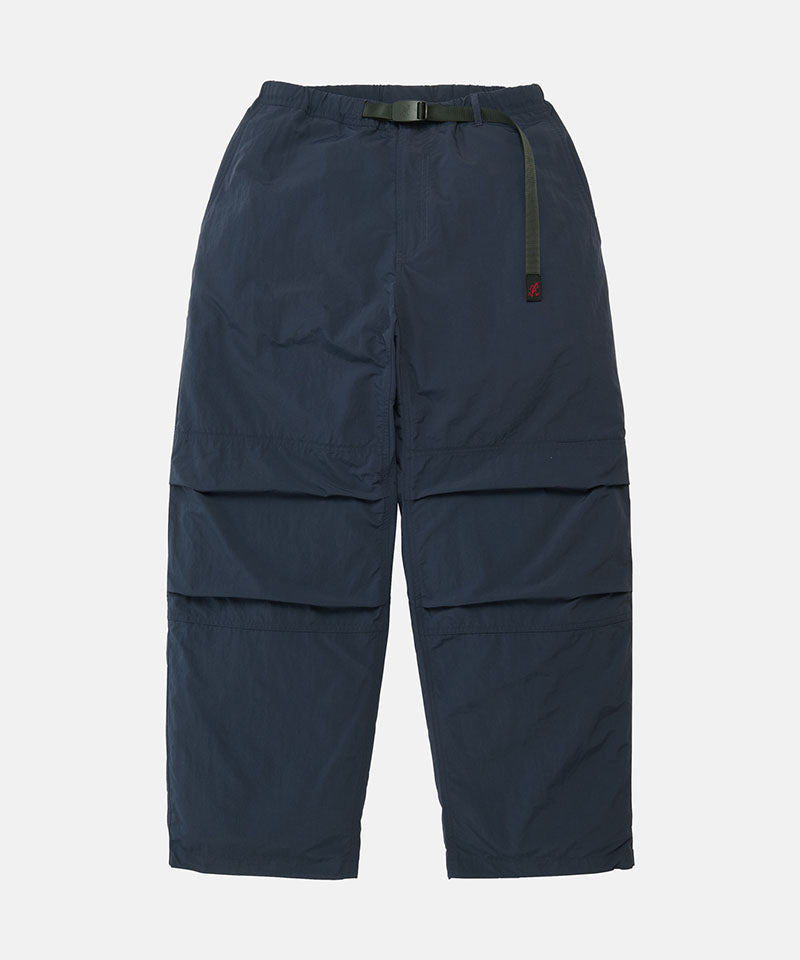 British navy Gramicci Nylon Paneled Trek Pants with a belt against a light-tone background.