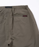 Back view close-up of granite colored Gramicci Nylon Paneled Trek Pants on a light-tone background.