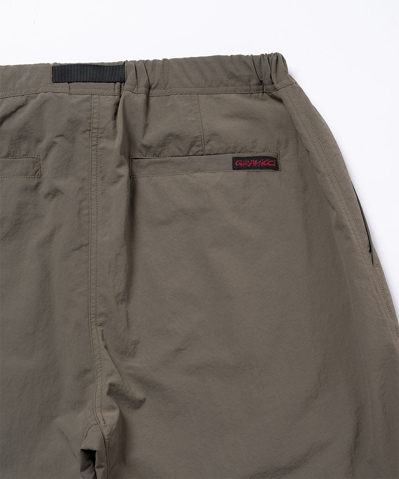 Back view close-up of granite colored Gramicci Nylon Paneled Trek Pants on a light-tone background.
