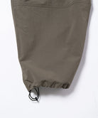 Granite colored Gramicci Nylon Paneled Trek Pants hem with drawstring on a light-tone background.