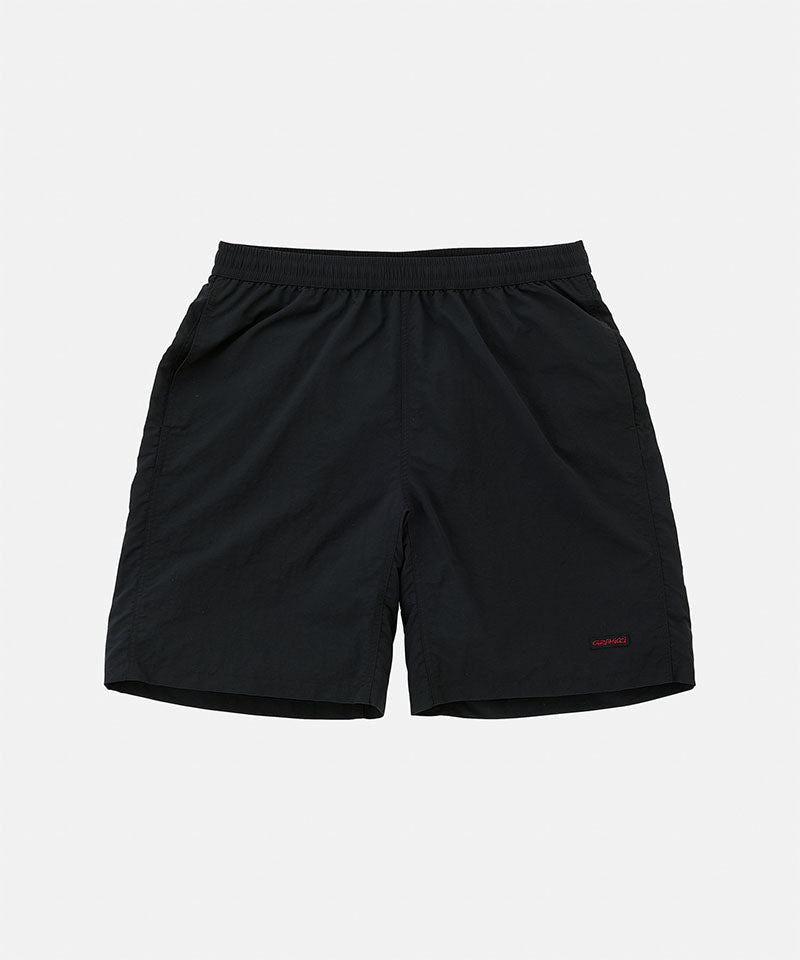 Black Gramicci Nylon Reef Shorts against a light-tone background.