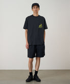 Model wearing black Gramicci Nylon Reef Shorts and a black shirt on a light-tone background.