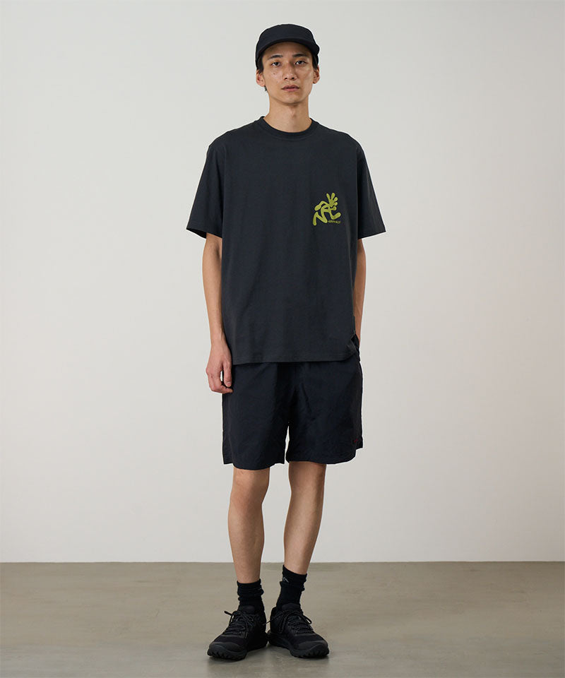 Model wearing black Gramicci Nylon Reef Shorts and a black shirt on a light-tone background.