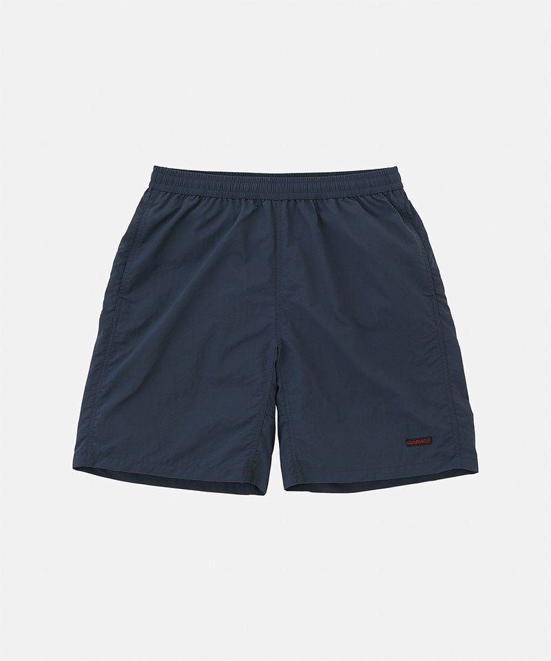 British navy Gramicci Nylon Reef Shorts against a light-tone background.