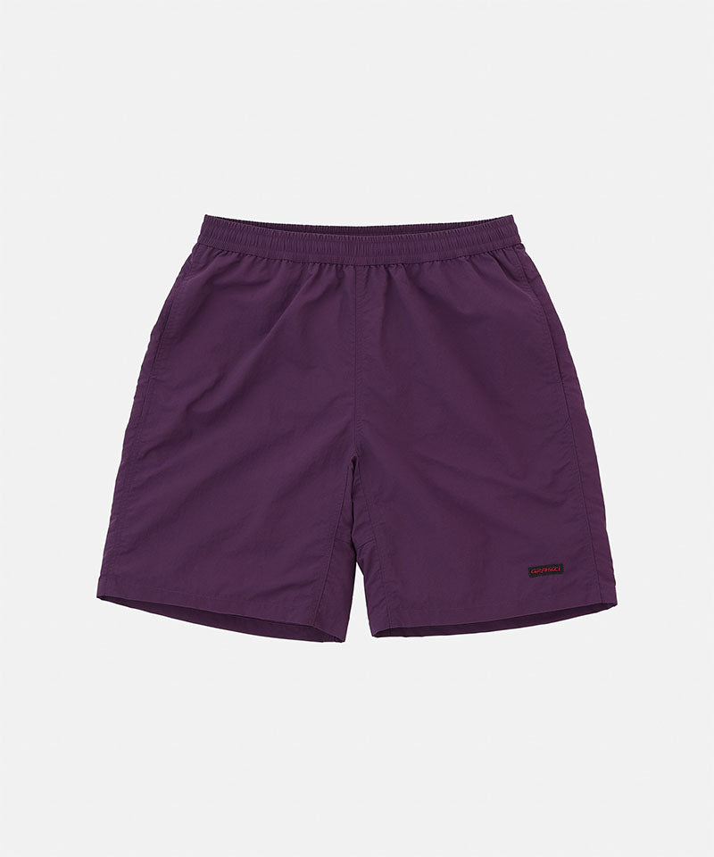 Deep purple Gramicci Nylon Reef Shorts against a light-tone background.