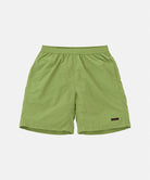 Jade green Gramicci Nylon Reef Shorts against a light-tone background.