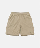 Milk tea colored Gramicci Nylon Reef Shorts against a light-tone background.