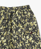 Back view of the Gramicci Nylon Reef Shorts in olive camo featuring a pocket with velcro closure on a light-tone background.